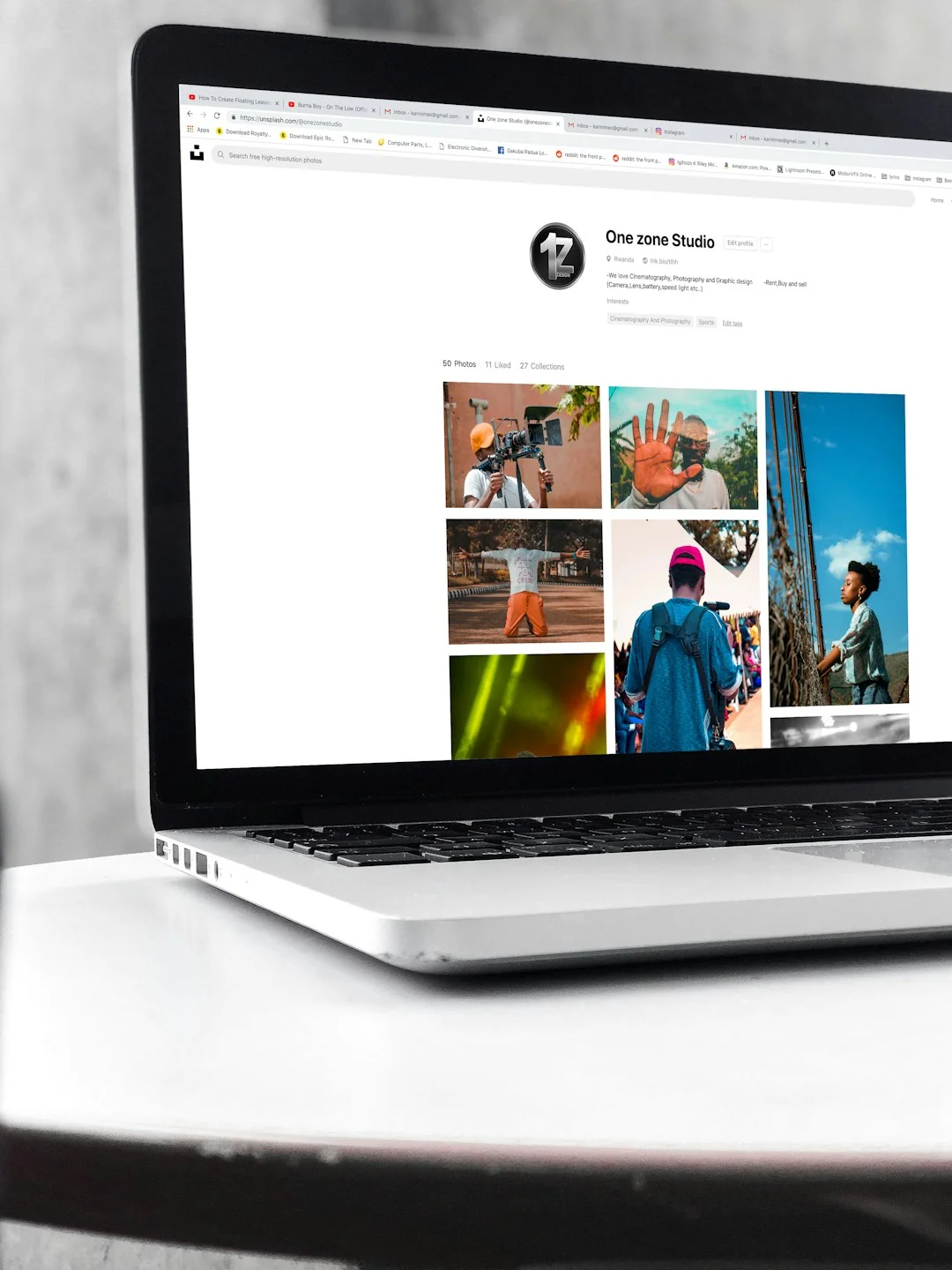Portable computer with website representing assorted abstract photos under favorites and browser search engine with magnifier symbol